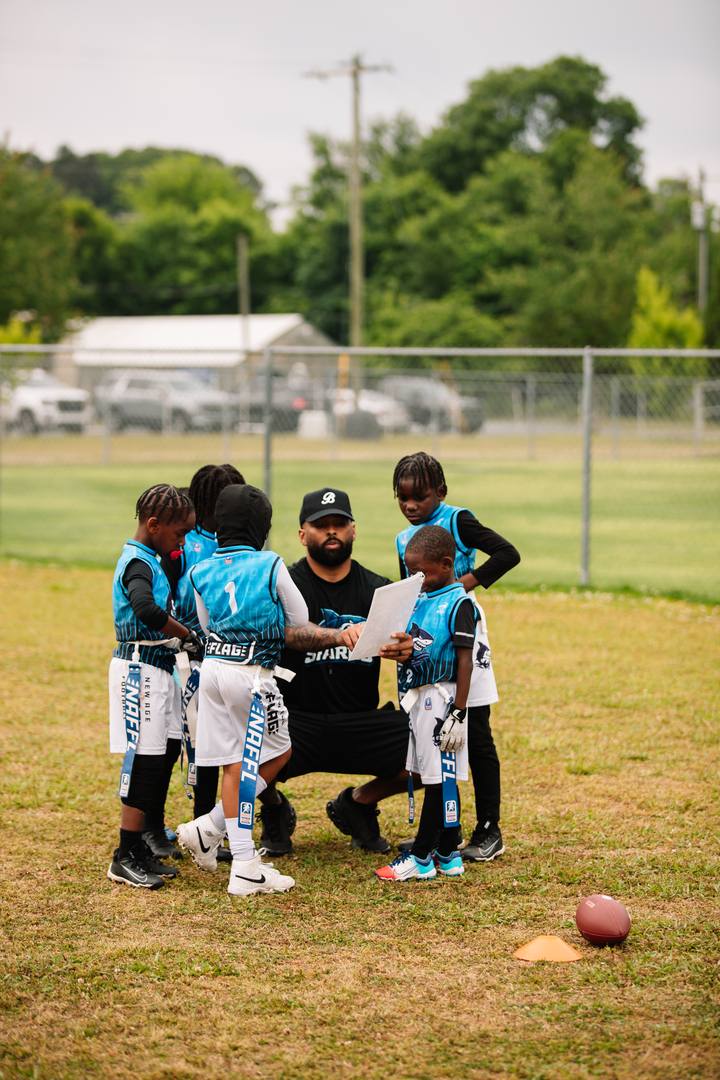 A coach walking the team through a play