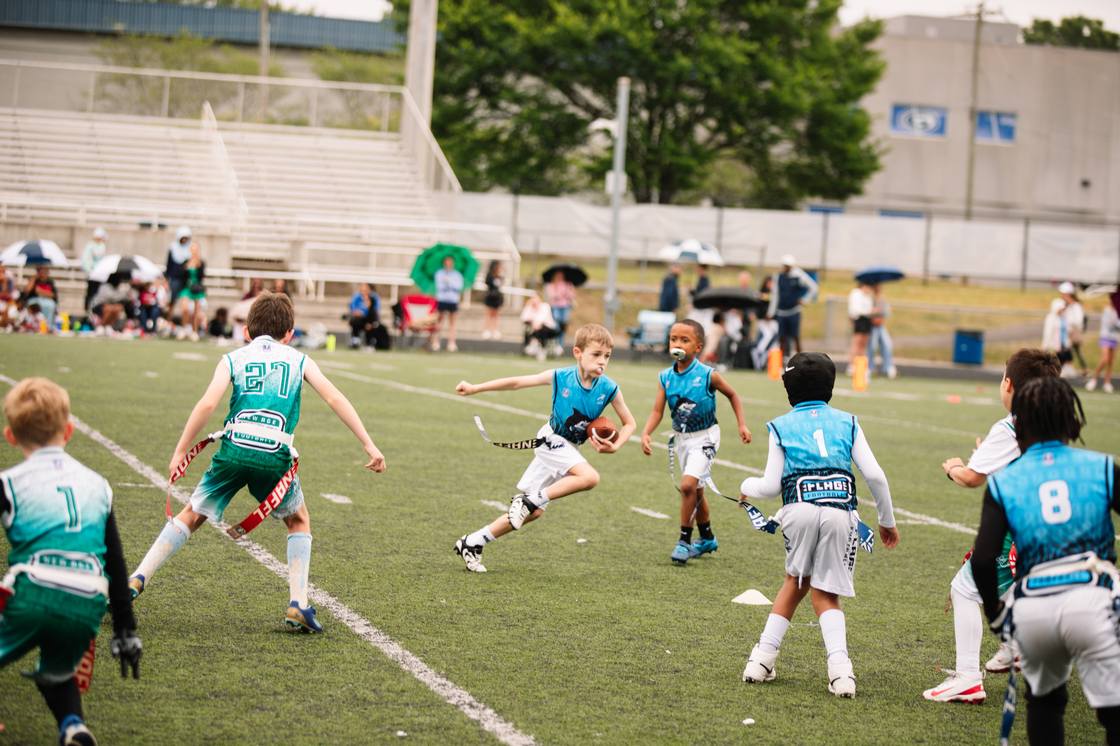 A Sharks athlete running the ball upfield