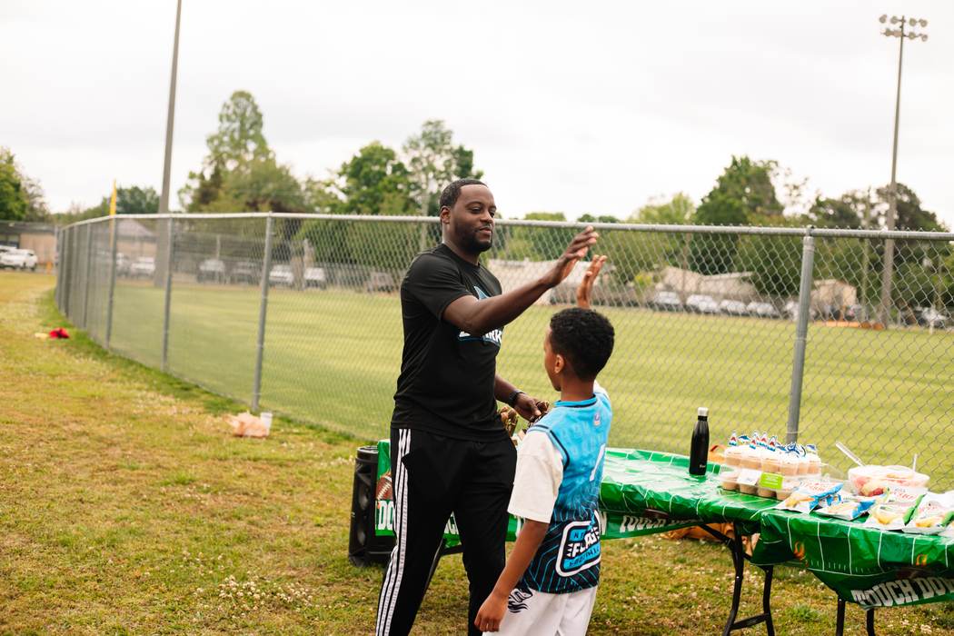 A coach and an athlete sharing a high five