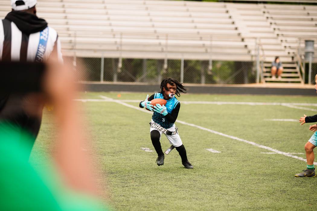 An athlete catching a pass in traffic