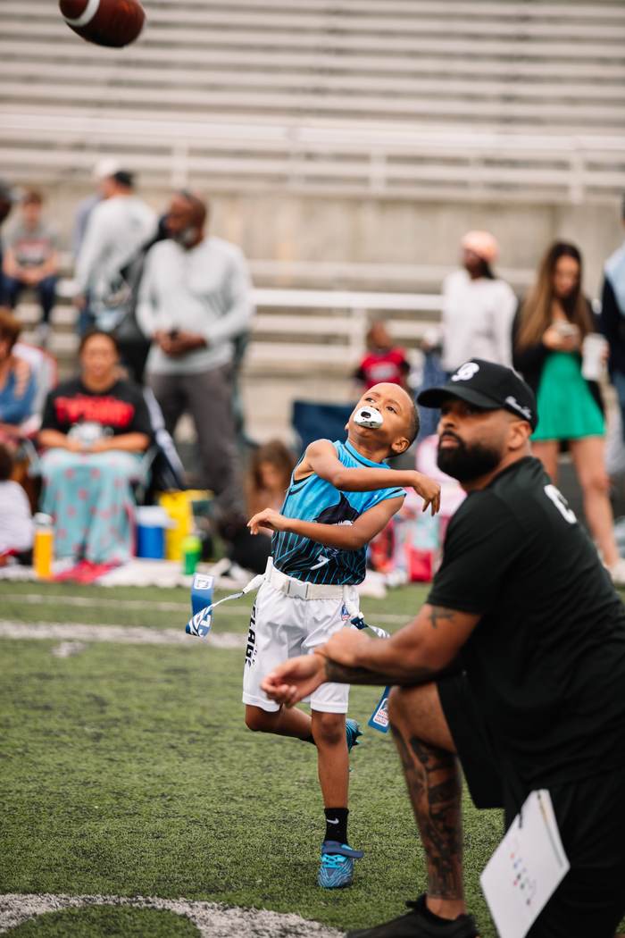 A quarterback letting one go